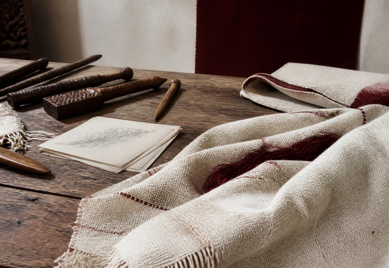 Handwoven ivory textile with oxblood details